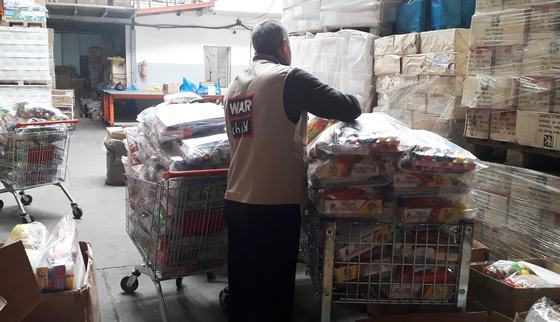 Checking samples psychosocial kits in Gaza_War Child_200414