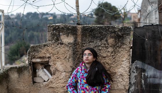 Girl standing in front of the gated walls_Hebron_OPT_War Child_191211