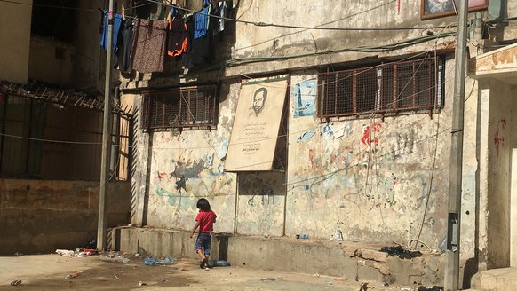 Boy walking in Tripoli, Lebanon nearby War Child programme