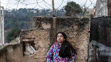 Girl standing in front of the gated walls_Hebron_OPT_War Child_191211