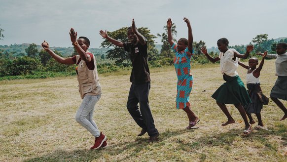 Group of Ugandans dancing in line - War Child projects TeamUp
