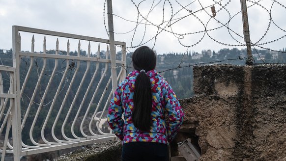 Girl from OPT in front of barbed wire_War Child in OPT_191211