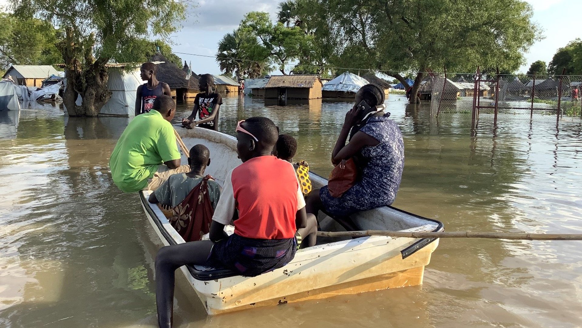 People in a boat going to the flooded houses after heavy rains in South Sudan_War Child_201107