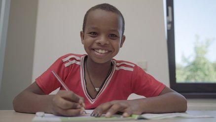 Smiling boy at school receives TeamUp