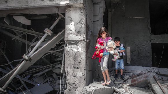 War Child in oPt_Israel-Gaza Conflict_children walking out of destroyed building_ANP_210519